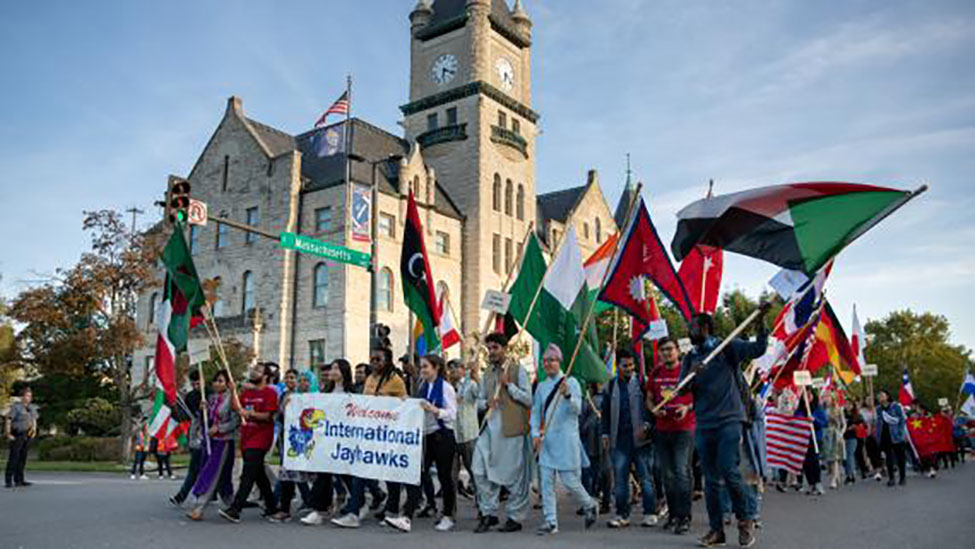 Homecoming parade with international flags in downtown Lawrence