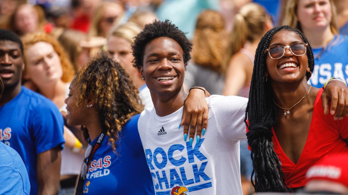 alt="A group of students at a football game"