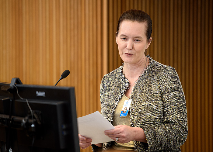 Dr. Laura Tatpati stands at a podium