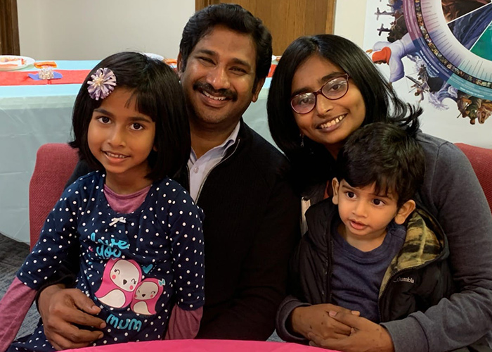 Samuel Durairaj and his wife seated with two young children on their laps